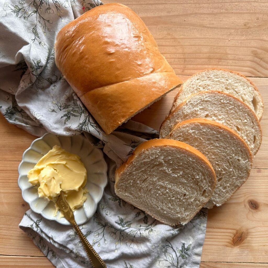 sliced honey white sandwich bread on a wooden countertop