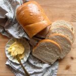 sliced honey white sandwich bread on a wooden countertop