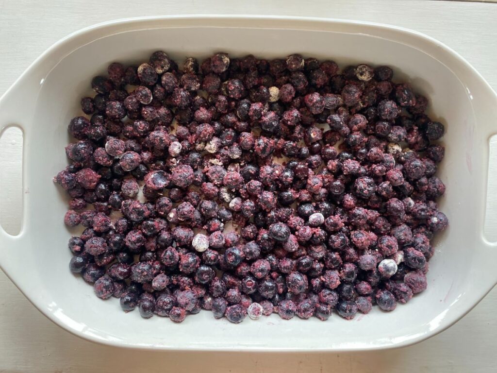 a large white baking dish full of blueberries