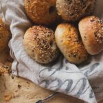 homemade bagels in a basket topped with everything bagel seasoning