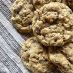 baked oatmeal chocolate chip cookies laying on a striped kitchen towel