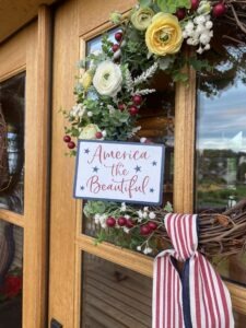 DIY 4th of july grapevine wreath hanging on a wooden door