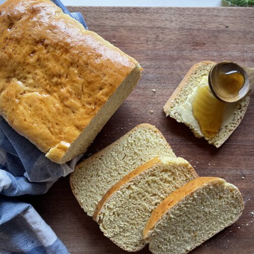 slices of einkorn sandwich bread on a wooden cutting board