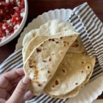 homemade flour tortillas on a white plate