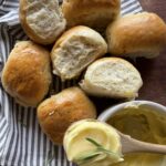 soft and fluffy rosemary garlic dinner rolls with softened butter