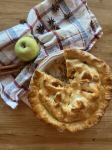 a baked sourdough apple pie in a round pie dish