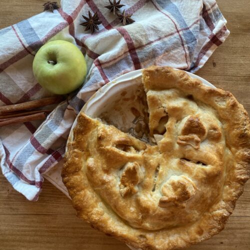a baked sourdough apple pie in a round pie dish