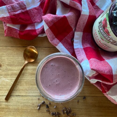 chocolate cherry smoothie on a table with a red and white checkered towel