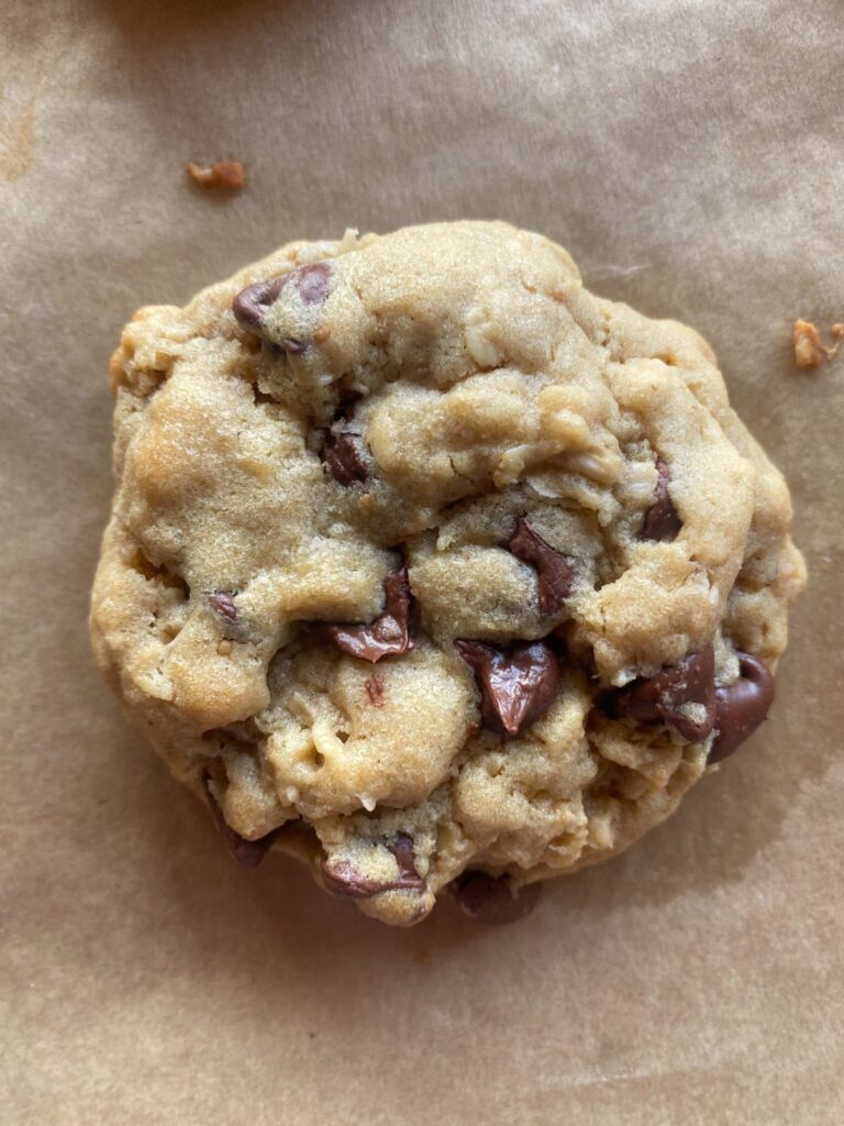 one peanut butter oatmeal chocolate chip cookie on a baking sheet