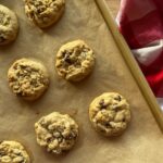 baked sourdough oatmeal cookies laying on a cookie sheet