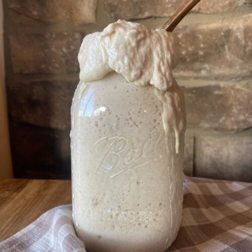 a mason jar full of bubbling active sourdough starter