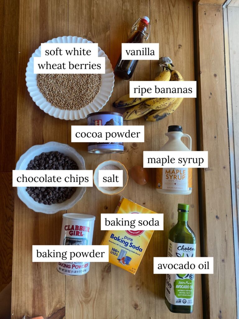 a labeled ingredient shot of ingredients needed to make chocolate banana muffins with fresh milled flour