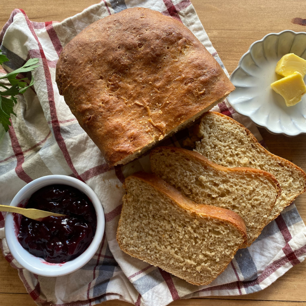 fresh milled flour sandwich bread cut into slices and laying on a striped towel