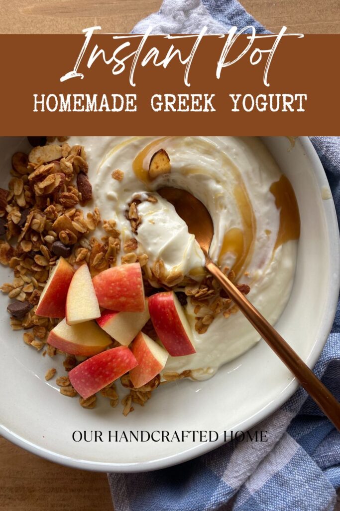 Bowl of Greek yogurt topped with apple slices, granola, and a drizzle of honey, with a copper spoon and blue kitchen towel in the background. Text overlay reads "Instant Pot Homemade Greek Yogurt."