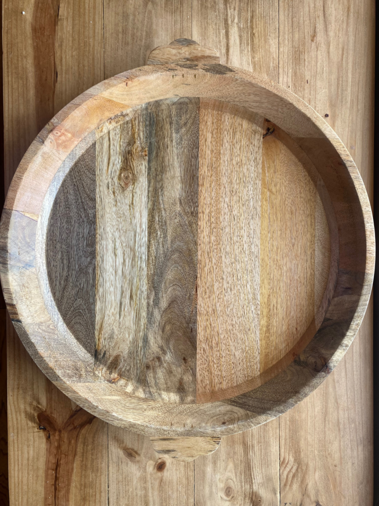 a large circular wooden serving tray 