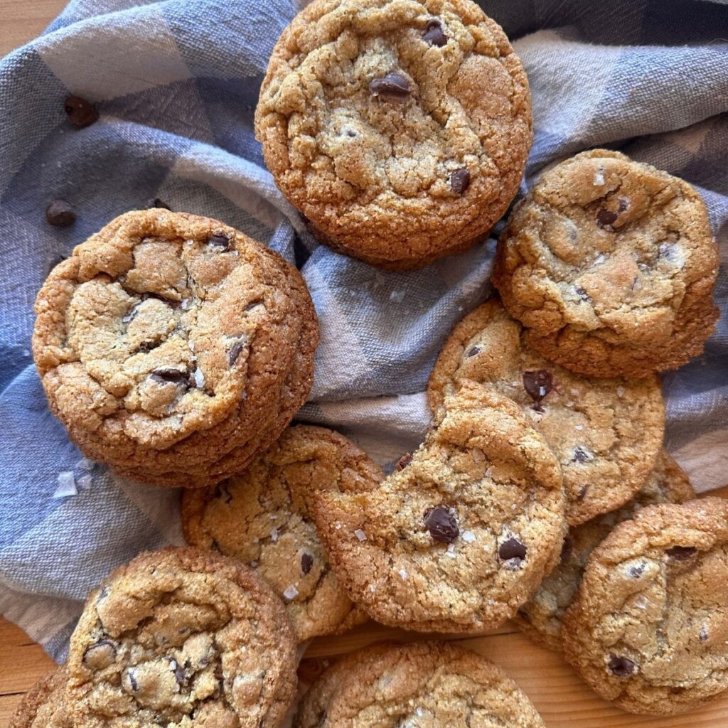 homemade fresh milled flour chocolate chip cookies arranged on a blue and white checkered towel