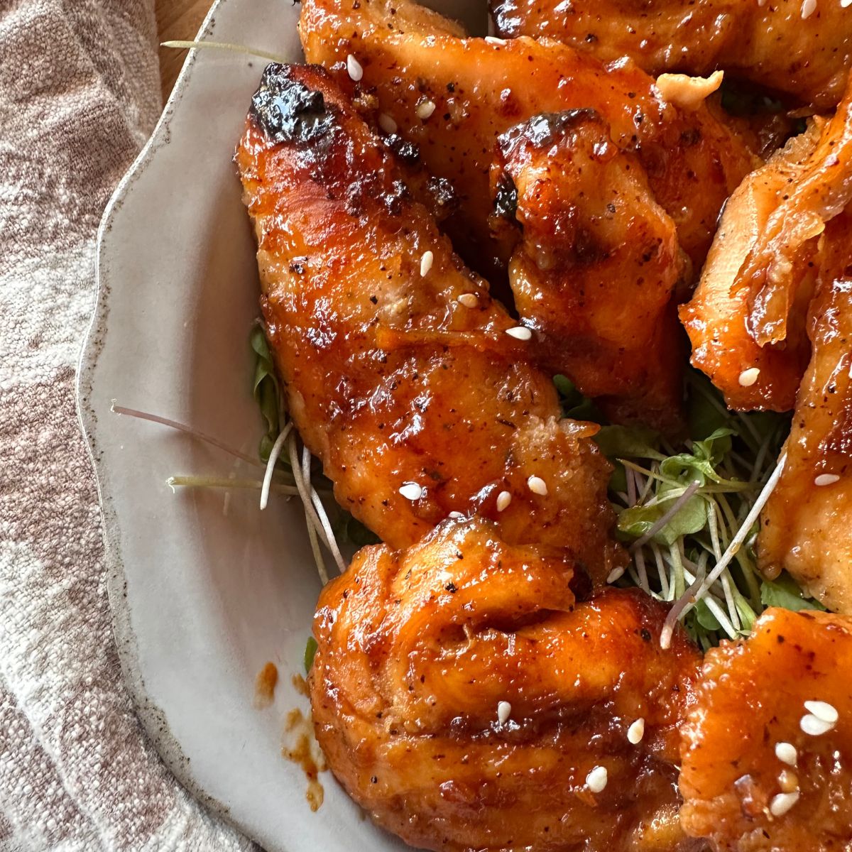 baked chicken tenders tossed in a honey garlic sauce, and topped with sesame seeds