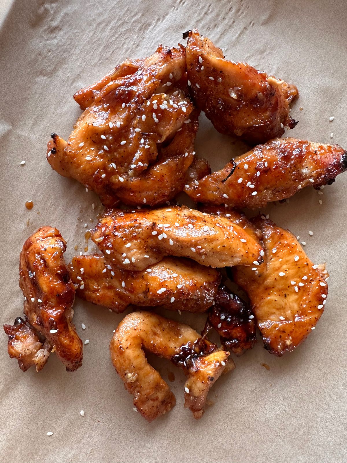 baked chicken tenders tossed in a honey garlic sauce and garnished with sesame seeds