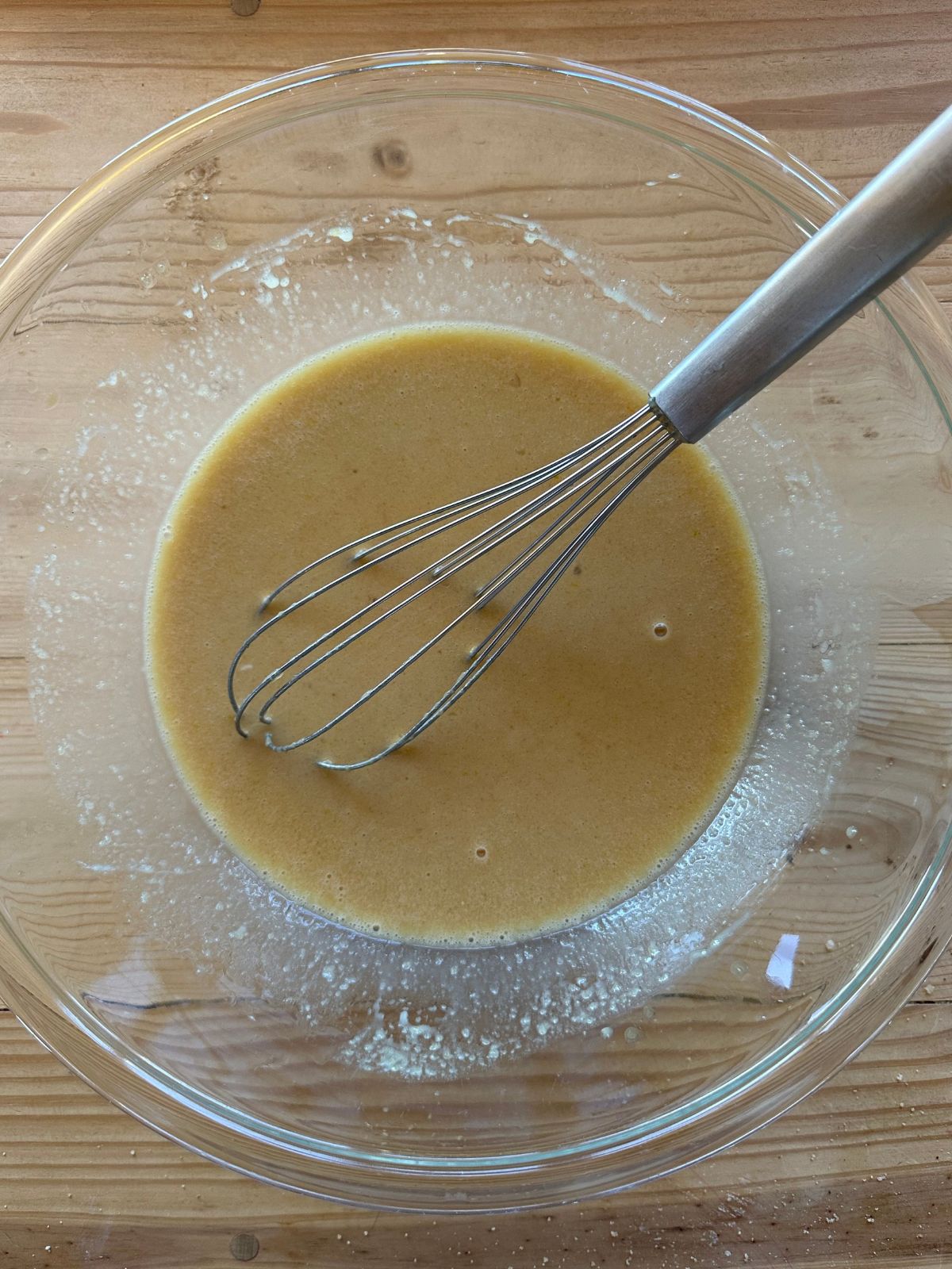 apple cider donut batter in a large glass mixing bowl