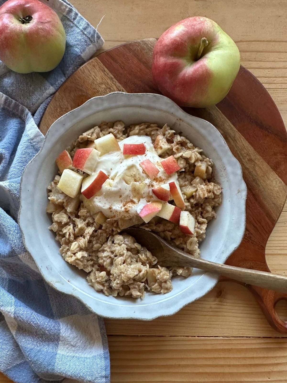 apple pie oatmeal garnished with fresh chopped apples and a dollop of vanilla yogurt